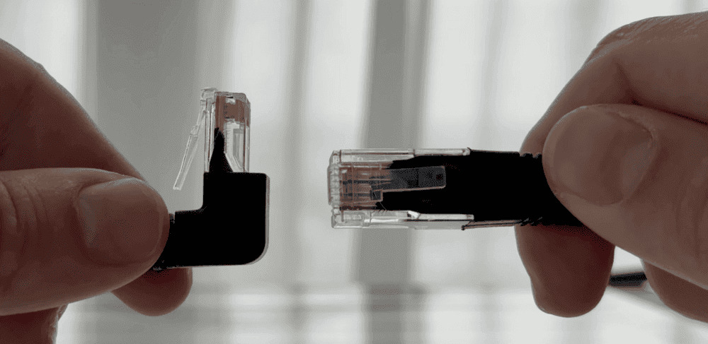An Ethernet cable with a plug on both ends, one of them right-angled.