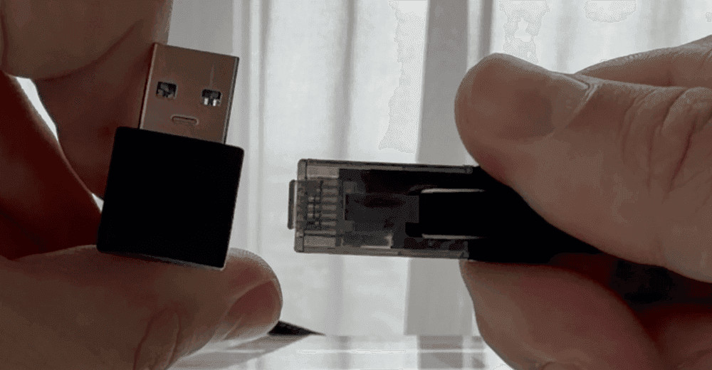 A cable with a USB plug on one end and an Ethernet plug on the other.